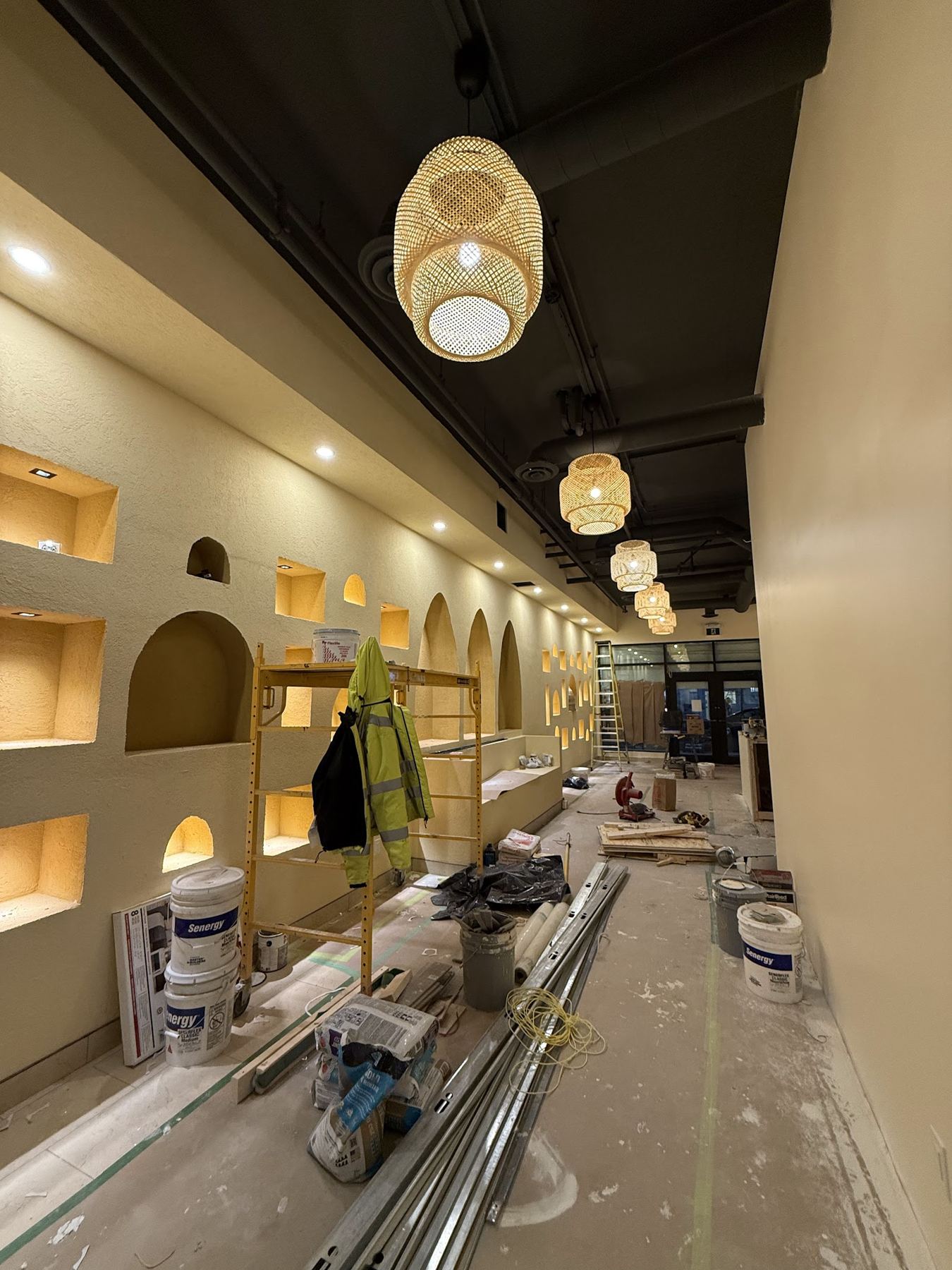A row of arched wall niches lit from inside in a commercial space