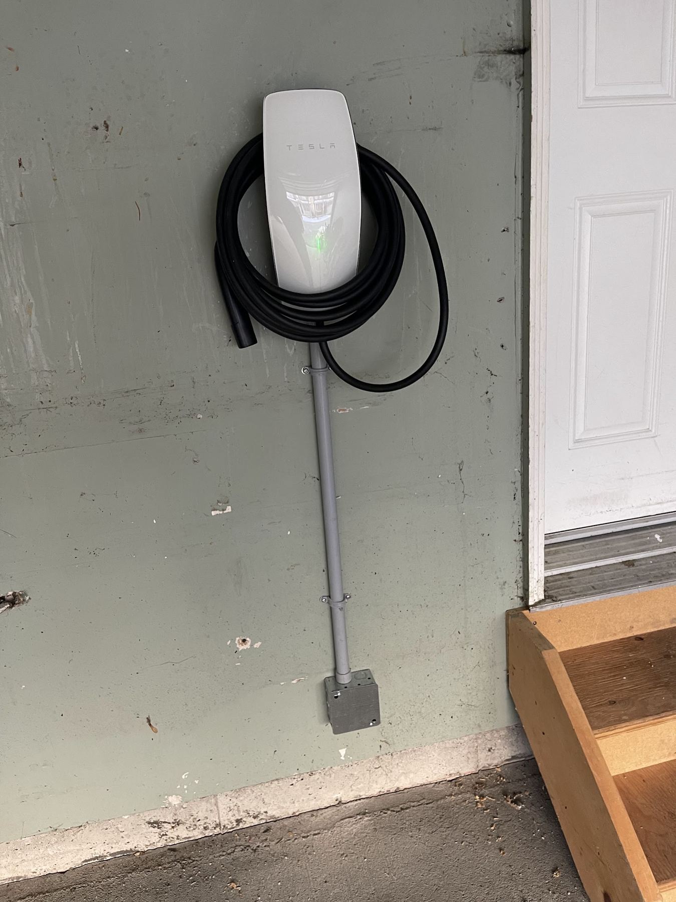 A wall-mounted EV charger in a garage