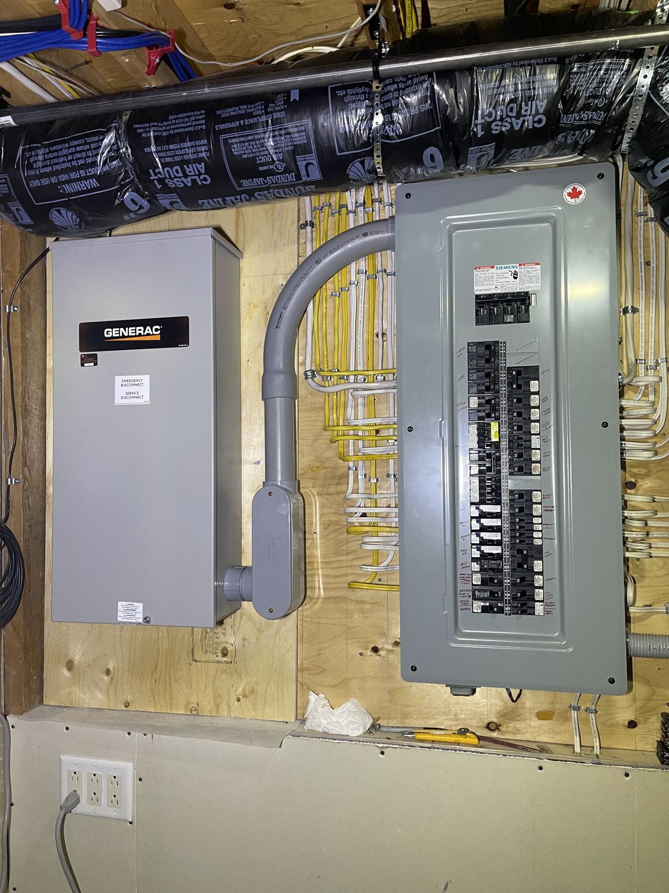 A new electrical panel beside a generator transfer switch