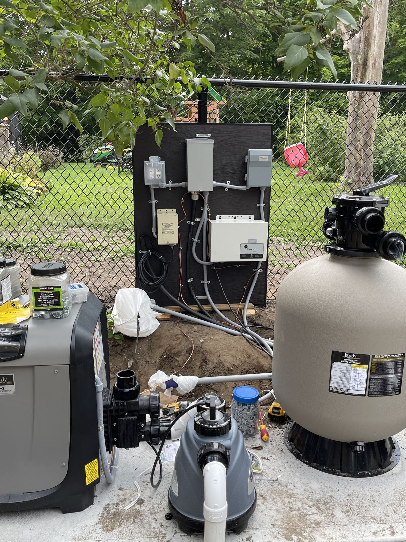 Wired pool pump, filter and heater equipment in a back yard